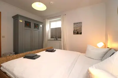 Ein Bett oder Betten in einem Zimmer der Unterkunft Birkenhof App 04, Ostseetraum