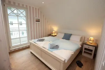Ein Bett oder Betten in einem Zimmer der Unterkunft Am Lütten Bagen Haus Darßzauber