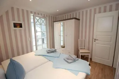 Ein Bett oder Betten in einem Zimmer der Unterkunft Am Lütten Bagen Haus Darßzauber