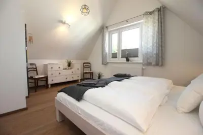 Ein Bett oder Betten in einem Zimmer der Unterkunft Ferienhäuser Ferienhaus, Uns Boddenhuesing