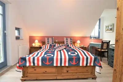 Ein Bett oder Betten in einem Zimmer der Unterkunft Ferienhäuser Uns Lütt Hus