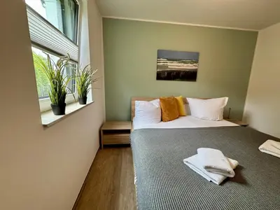 Ein Bett oder Betten in einem Zimmer der Unterkunft Aquamarin Ostseetraumsuite 02