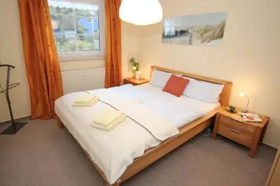 Ein Bett oder Betten in einem Zimmer der Unterkunft Mühlenweg, App 01