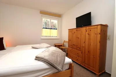 Ein Bett oder Betten in einem Zimmer der Unterkunft Am Leuchfeuer Haus Seeblick, App 03