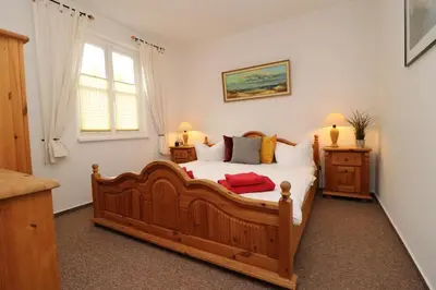 Ein Bett oder Betten in einem Zimmer der Unterkunft Am Leuchfeuer Haus Seeblick, App 03