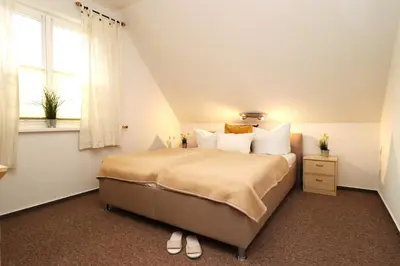 Ein Bett oder Betten in einem Zimmer der Unterkunft Am Leuchfeuer Haus Seeblick, App 04