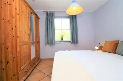 Ein Bett oder Betten in einem Zimmer der Unterkunft Am Leuchfeuer App 05