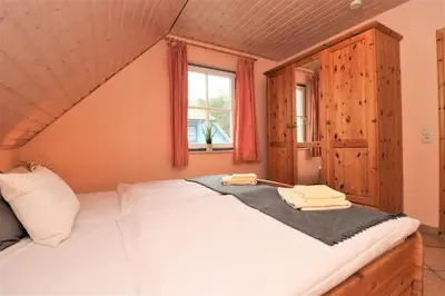 Ein Bett oder Betten in einem Zimmer der Unterkunft Am Leuchfeuer App 06