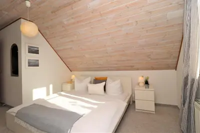 Ein Bett oder Betten in einem Zimmer der Unterkunft Ferienhäuser Doppelhaushälfte, Grüner Weg