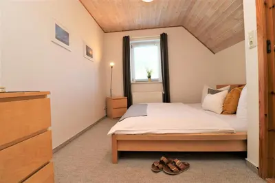 Ein Bett oder Betten in einem Zimmer der Unterkunft Ferienhäuser Doppelhaushälfte, Grüner Weg